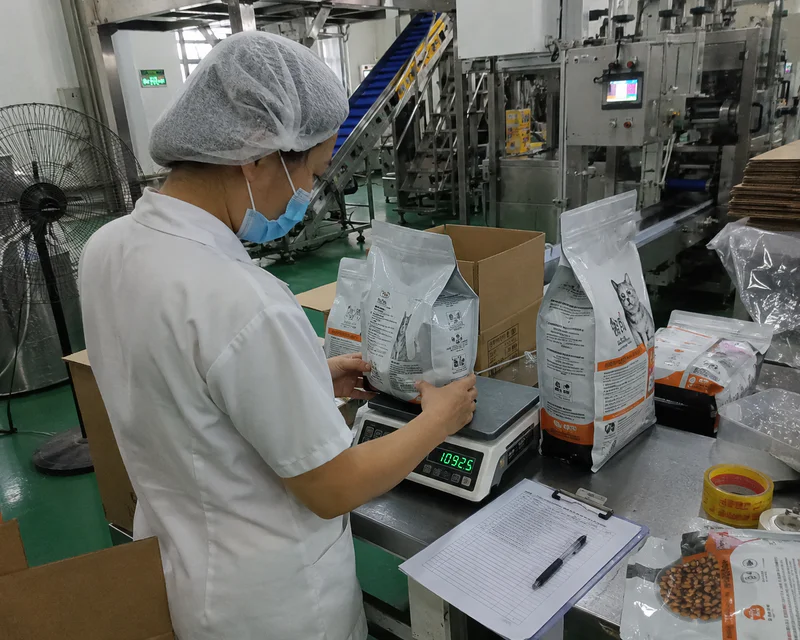 Checking flavor coating on kibble surface