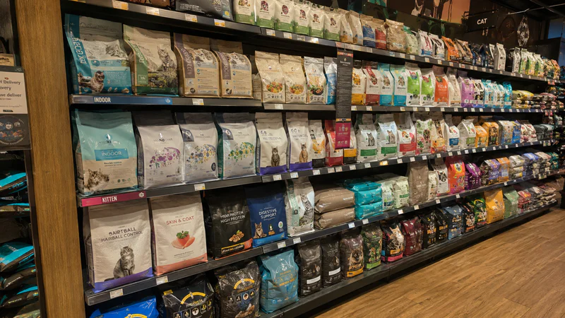 Retail-ready dry cat food packaging on shelves